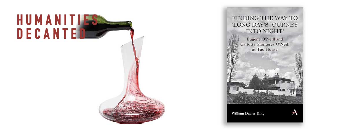 a wine decanter next to a book